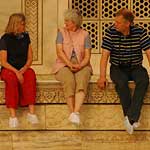 Three package tourists enjoying a break before they're rushed back into their air-conditioned bus ... they had a total of 45 minutes to view the Taj!