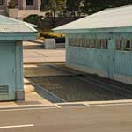The raised concrete line between the two blue UN controlled buildings marks the border between North and South Korea...