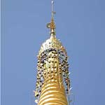 This is called a hti, or umbrella - the one at Shwedagon has several thousand precious stones attached. Naturally it's also covered with gold leaf